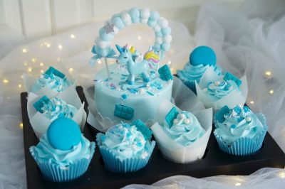 Blue unicorn cake with cupcakes