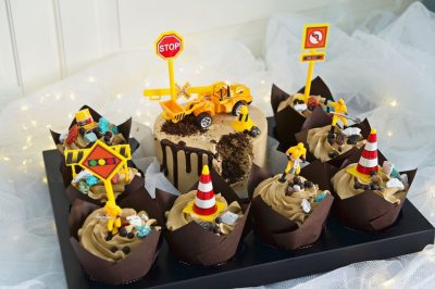Construction trucks theme cake with cupcakes
